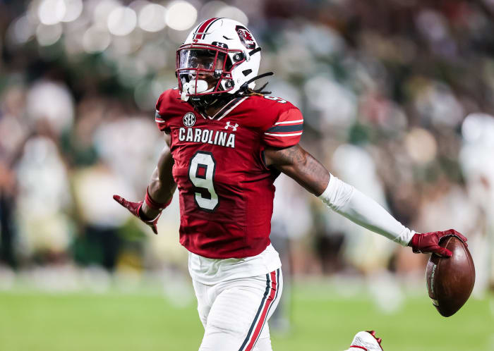 South Carolina Gamecocks defensive back Cam Smith runs with his arms out, football in one hand